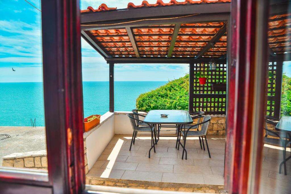 Private balcony with a table for four looking straight out over the sea