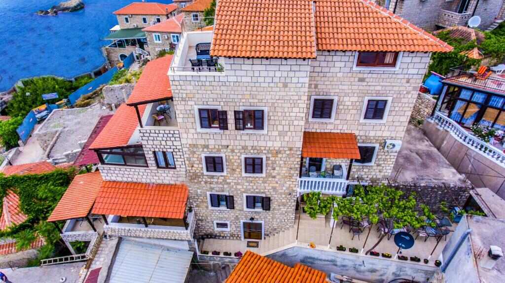 Villa Marinero seen from above among the stone houses and red roofs of Old Town Ulcinj